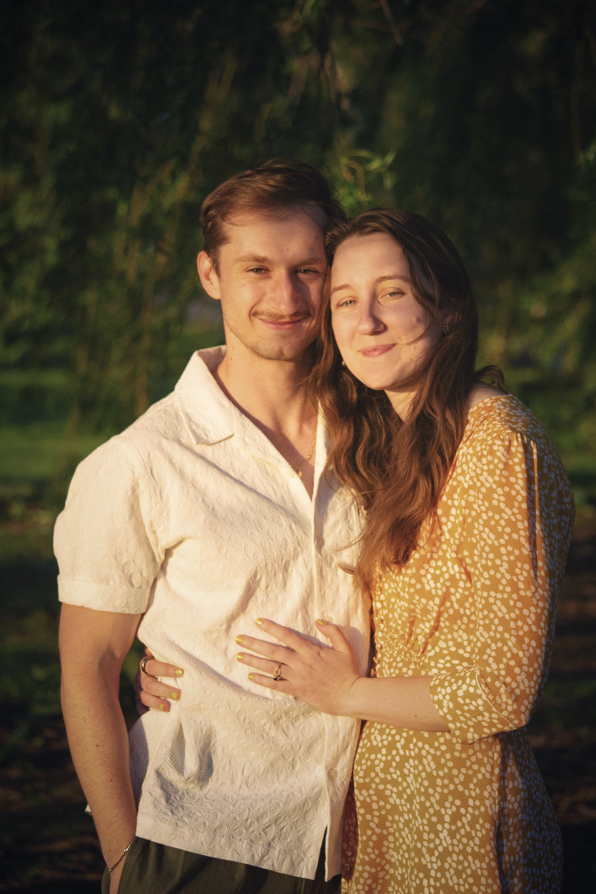 Courtney and Christian embracing outdoors at golden hour
